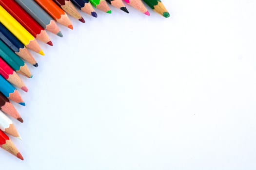 White background for presentation with colourful right upper round corner of multicoloured wooden pencils