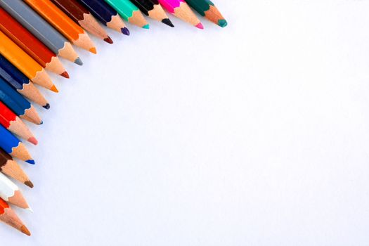 White background for presentation with colourful right upper round corner of multicoloured wooden pencils