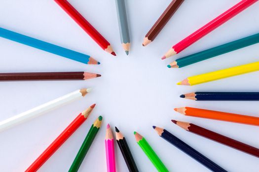 White background for presentation slide with colourful wooden pencils with circle copy space