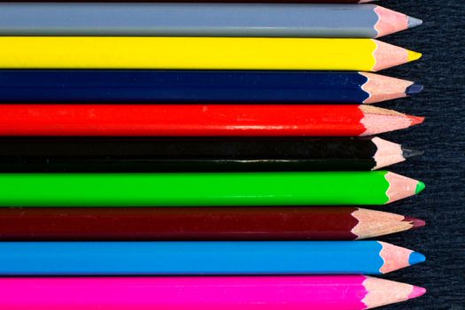 Horizontal colourful stripes of multicoloured wooden pencils background for presentations