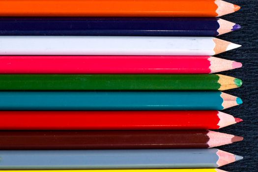 Horizontal colourful stripes of multicoloured wooden pencils background for presentations