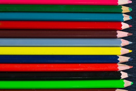 Horizontal colourful stripes of multicoloured wooden pencils background for presentations