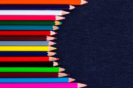 Black background for presentation with vertical colourful right round border of multicoloured wooden pencils