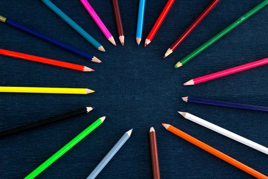 Black background for presentation slide with colourful wooden pencils with circle copy space