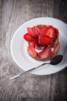 Strawberry and custard tart on a white plate 