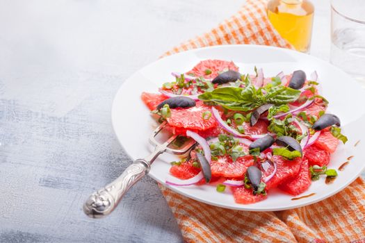 Grapefruit salad with olives, red onion basil