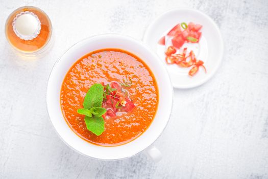 Bowl of Fresh tomato soup Gazpacho on a white background.