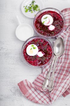 Bowl of beetroot soup with sour cream and eggs.