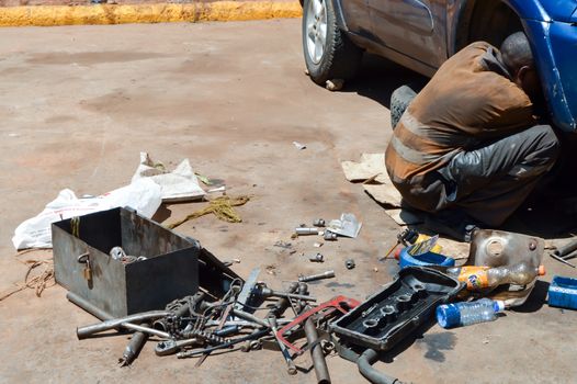 Mechanic car in full working on the floor on a parking lot in Kenya