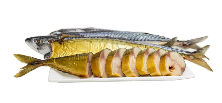 Sliced and whole cold-smoked Atlantic mackerel on a white dish against the backdrop of uncooked fish on a light background
