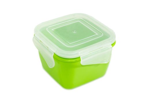 Green reusable plastic food storage container with translucent cover for home use on a light background
