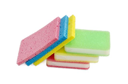 Several various synthetic cleaning sponges different colors, some of which are layered, on a light background
