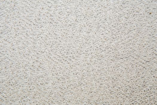 Macro shot of a terrycloth texture background. white Textile floor covering. Grey Knotted-pile carpet