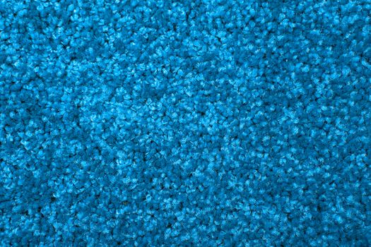 Macro shot of a carpeting texture background. Textile floor covering. Blue Knotted-pile carpet