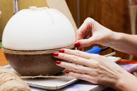 Female hands decorating handmade candles