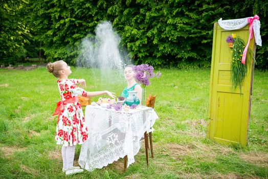 mother with daughter have a breakfast in the garden