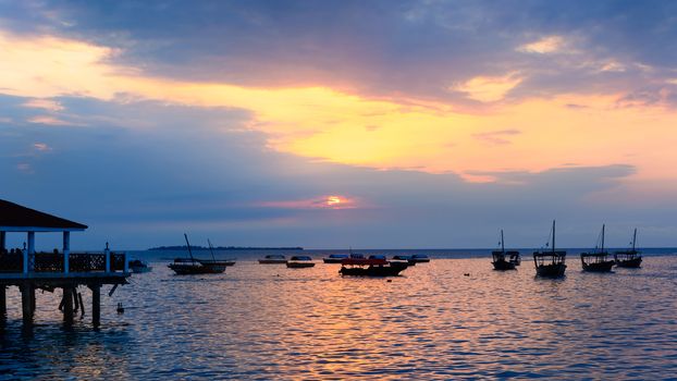 Typical boats docked in the port of  Stone Town ,Zanzibar, Tanzania republic, at sunset.