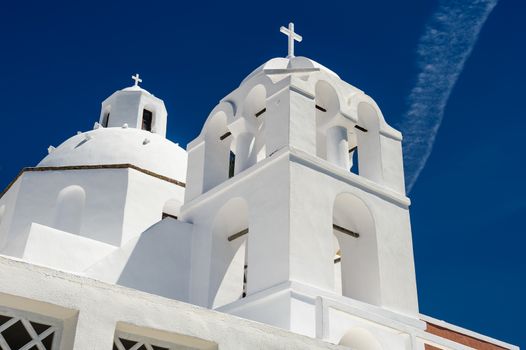 White orthodox church with bell tower. Fira, Santorini Greece. Copyspace