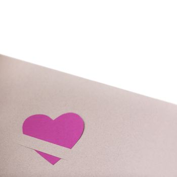 Pink paper hearts on light paper textured background