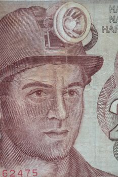 worker in a helmet with a lantern portrait on a banknote
