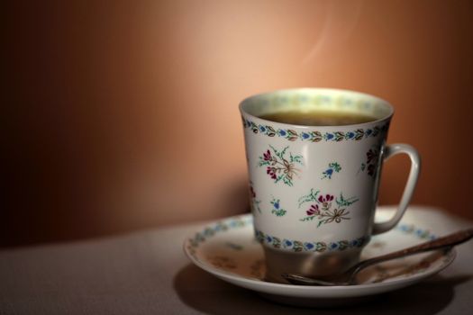 cup with hot tea and steam on background macro shot