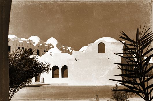 retro photo, on which image of palm trees near white structure in Egypt