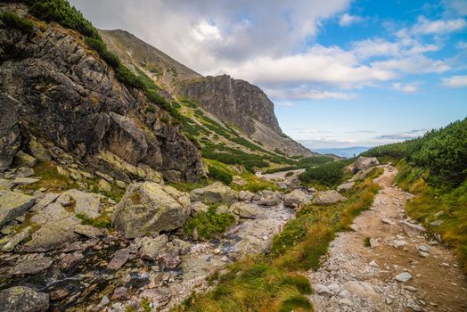 Hiking Trail near a Creek. Mountain Landscape on Cloudy Day. Mlynicka Valley, High Tatra, Slovakia.