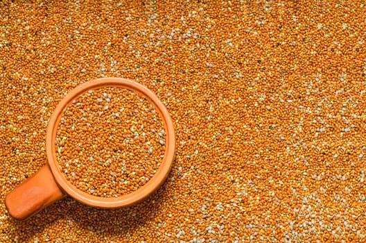 Background from untreated millet seed scattered on the surface and filled the Cup. Selective focus