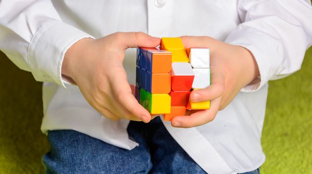 Child holding a Rubik's Cube