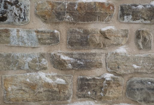 Wintry stone wall background with mortar