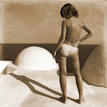 retro photo of girl which stands on the beach
