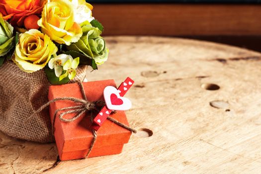 Gifts and bouquets of flowers on the wooden.