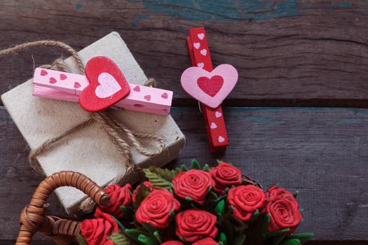 Heart and gift boxes on a wooden floor.