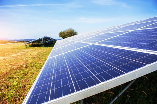 Solar panels on the lawn with the light at sky.