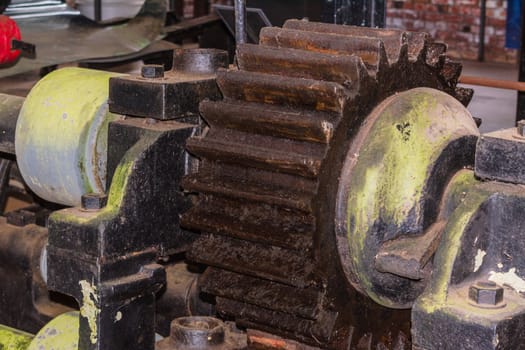 Closeup of a gear wheel of an ancient antique machine.
