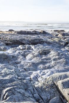 beautiful soft waves break on the rocks at ballybunion beach in ireland