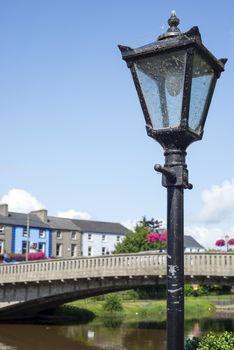 beautiful antique street lamp and riverside view of town and bridge