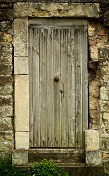 Old Wooden Door in Obsolete Stone Wall closeup Outdoors