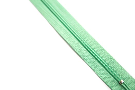 Green zipper isolated on white background