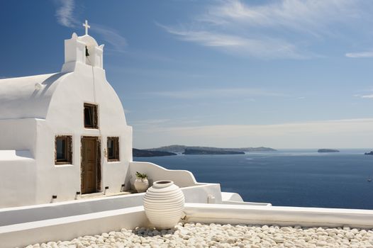 White orthodox church with bell tower. Oia, Santorini Greece. Copyspace