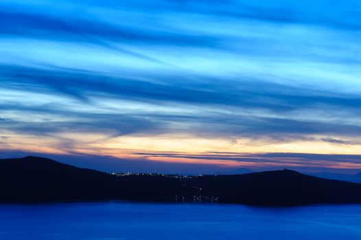 Dramatic colorful sunset at Santorini, Greece. View to caldera sea.