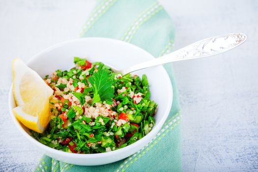 Quinoa tabbouleh salad on a wooden table.