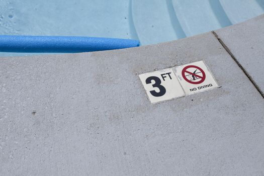 Sign indicating the depth of a swimming pool area