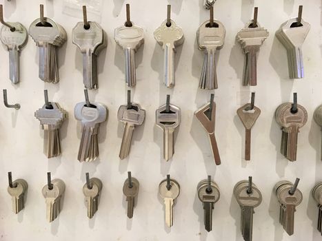 Closeup of Locksmith stand with variety of keys on the hooks.