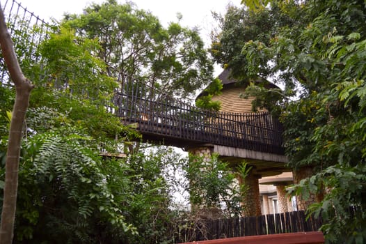 Wooden walkway with a room on stilts in the scenery of the savanna of West Tsvo Park in Kenya