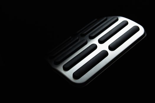 Car Pedal. In the deep shadows. Black background