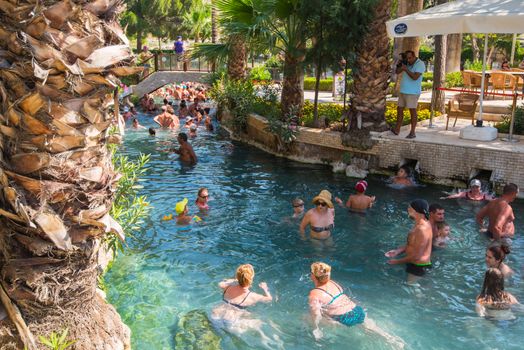 Pammukale, Turkey - July, 2015: photo of people at thermal Cleopatra pool in ancient city Hierapolis, near modern Turkey city Denizli