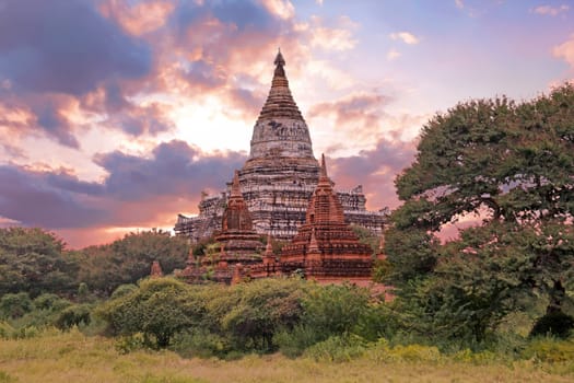 Ancient pagodas in the countryside from Bagan in Myanmar at sunset