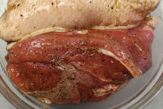 raw duck meat with spices prepared for roasting