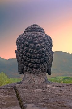 Buddha on the Borobudur Buddhist Temple (UNESCO World Heritage Site) - Java, Indonesia at sunrise

